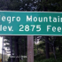 Green roadsign show elevation of Negro Mountain as 2,875 feet