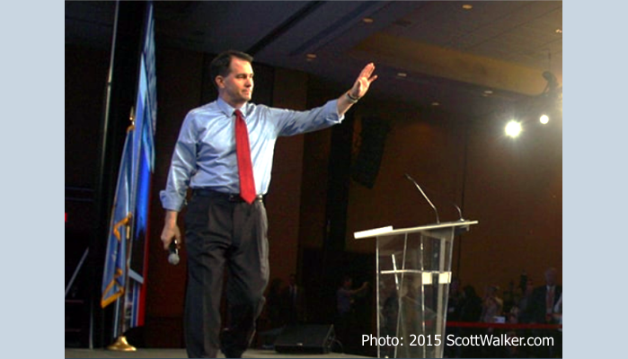 Scott Walker on stage at campaign waving goodbye as he ends his campaign.