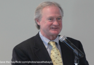 Lincoln Chafee speaking from a podium in Rhode Island